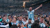 Lionel Messi is carried through the stadium after Argentina wins the 2022 FIFA World Cup