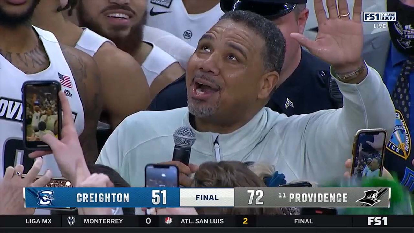 Providence coach Ed Cooley makes a speech after the Friars secure their first Big East title