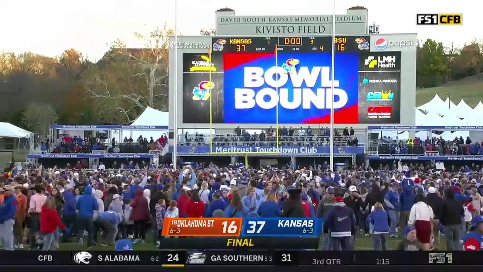 Kansas Jayhawks fans storm the field after they beat Oklahoma State