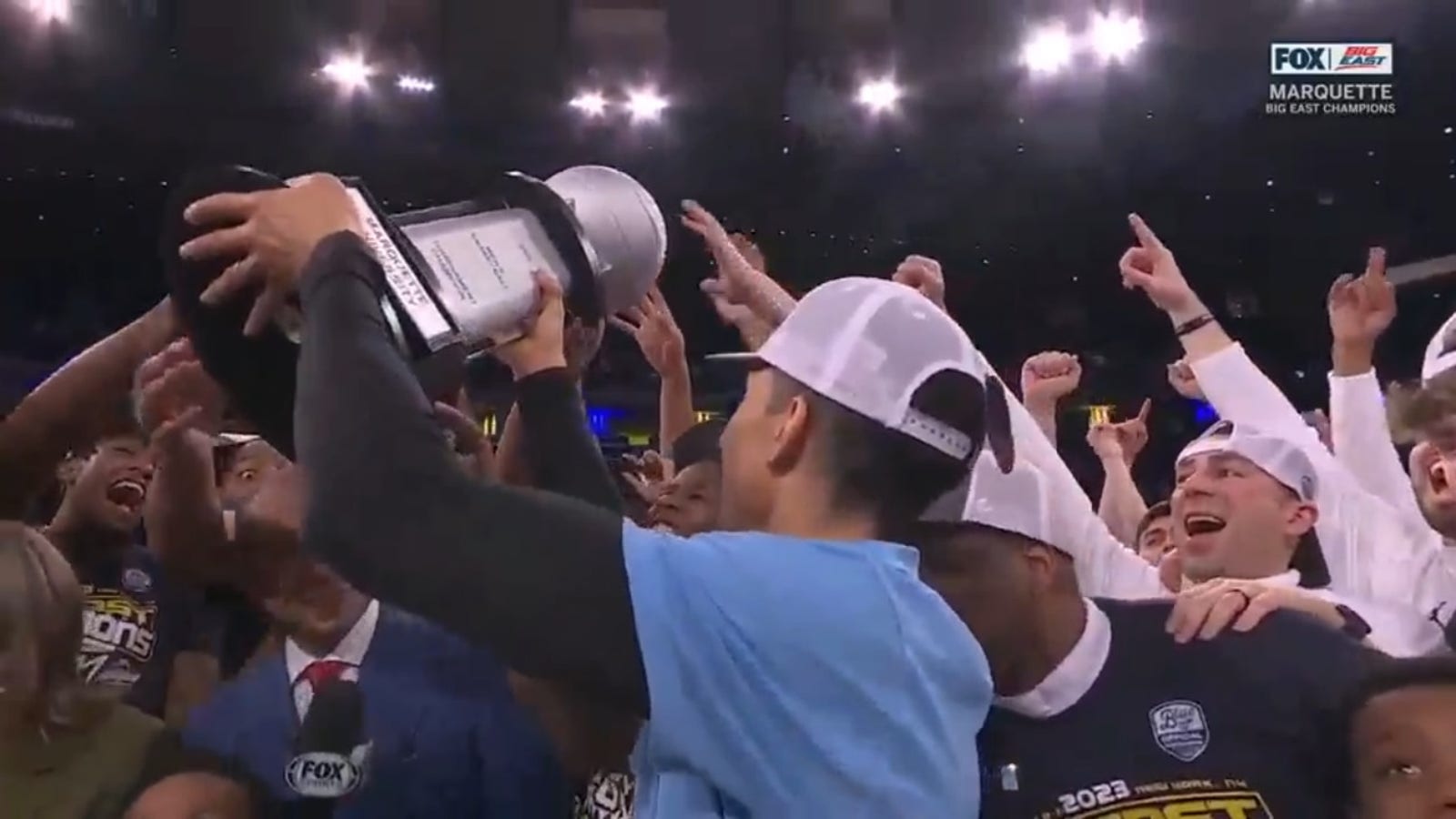 Marquette hoists the trophy