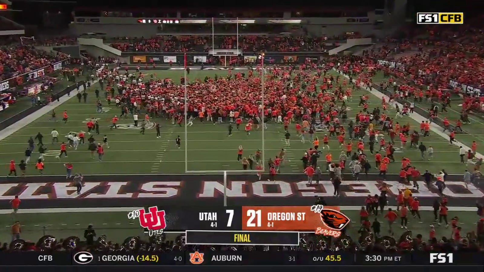 Oregon State fans storm the field after defeating Utah