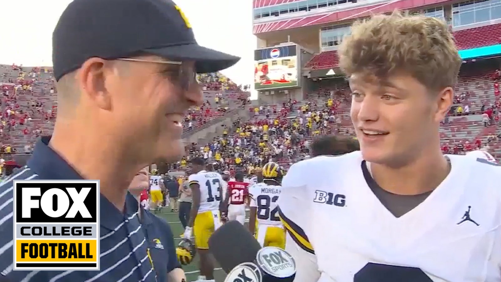 Jim Harbaugh and J.J. McCarthy talk to Allison Williams after the game