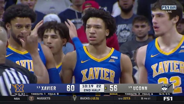 Desmond Claude makes an acrobatic layup boosting Xaviers lead over UConn