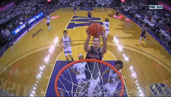 Arizona's Azuolas Tubelis slams down the break-away dunk to trim Washington's lead