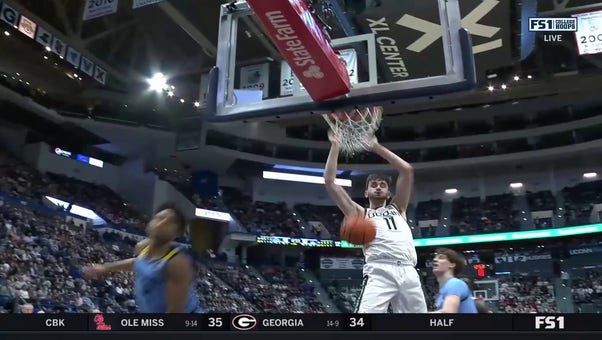 UConn's Alex Karaban delivers the two-handed jam off a beautiful pass from Tristen Newton 