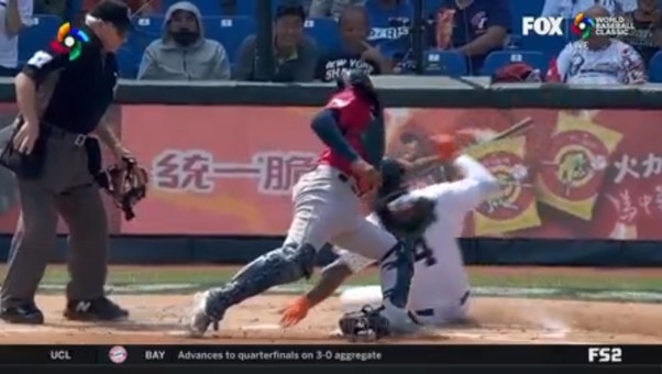 Panama's Allen Córdoba misplays a ball in left but makes up for it as he throws out the runner at home