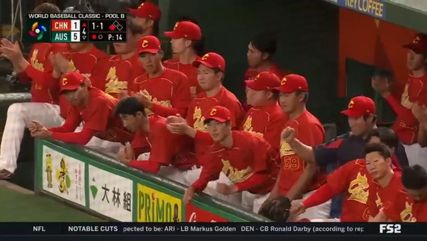 China's Ray Chang scores on a wild pitch by Australian pitcher Luke Wilkins in the fourth inning