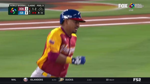 Venezuela's Eduardo Escobar crushes a homer to center field against Israel