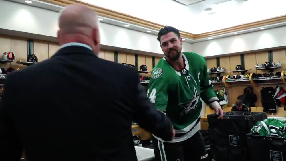 The captain honors the coach with his first game puck after Stars win on Opening Night