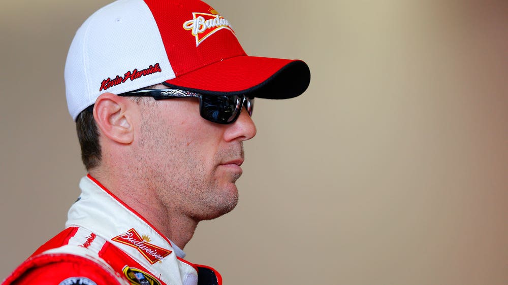 Time's up: Kevin Harvick runs out of laps in his pursuit of Logano
