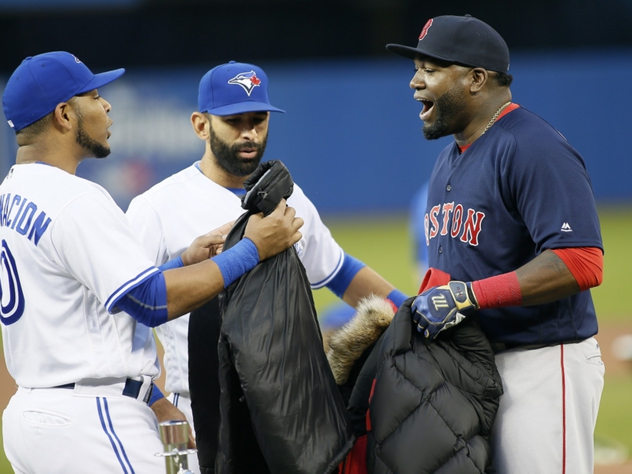 Blue Jays Encarnacion and Bautista warm up under red sky while the