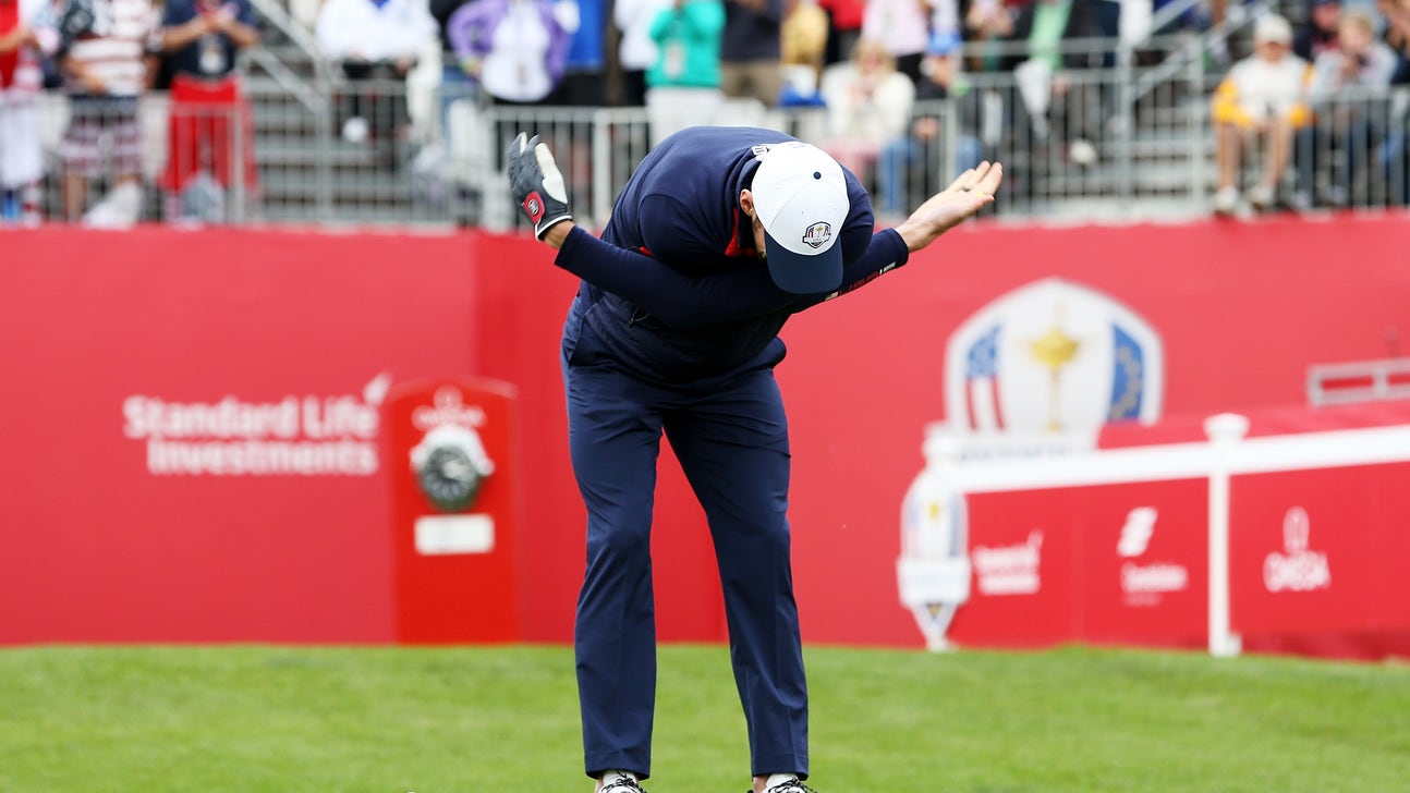Michael Phelps breaks out his signature arm flap before teeing off at Ryder Cup