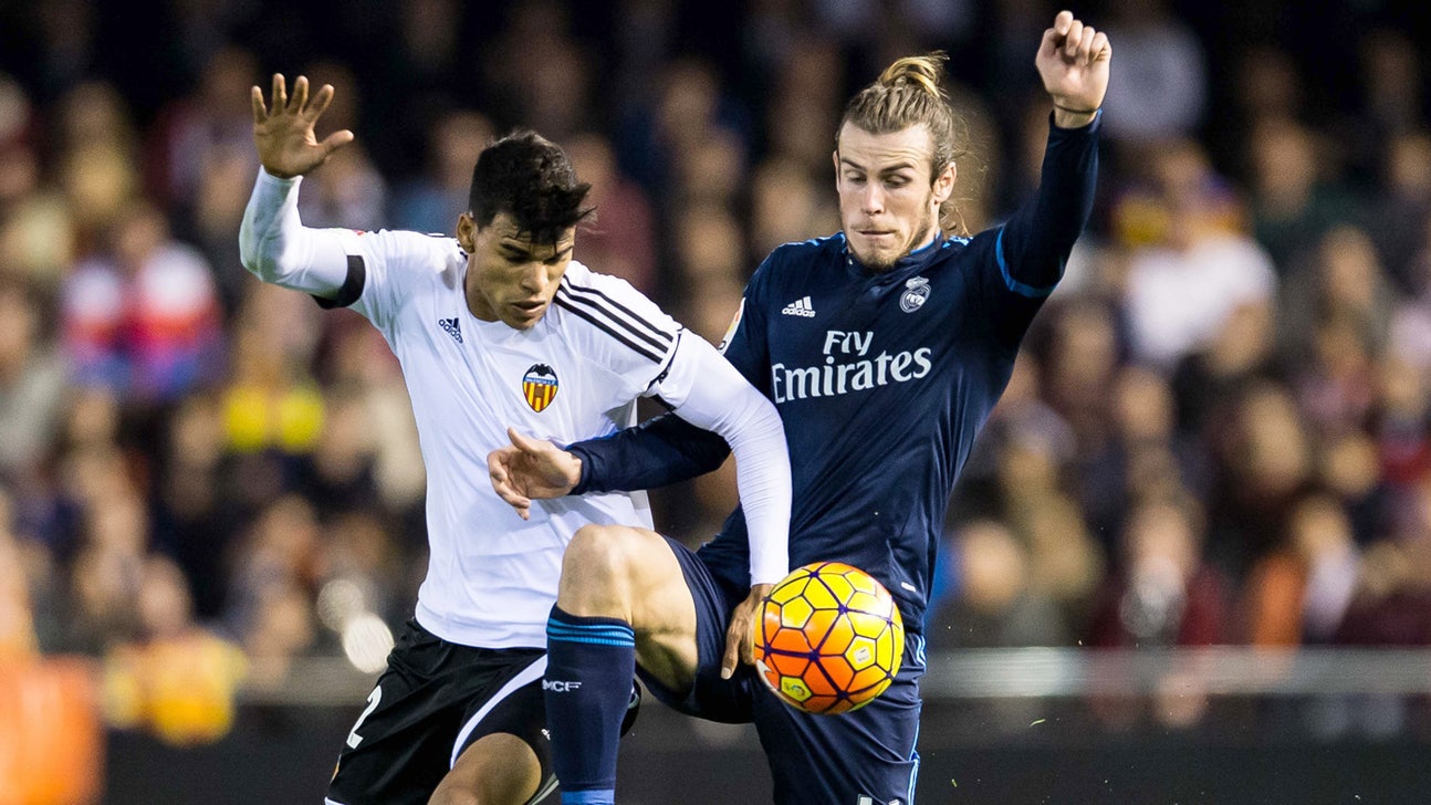 Valencia battle back twice to draw with ten-man Real Madrid