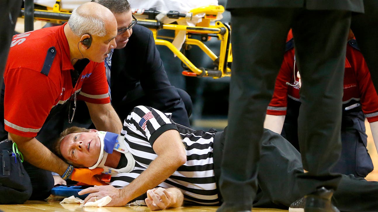 NCAA referee OK after getting hit in face on opening tip