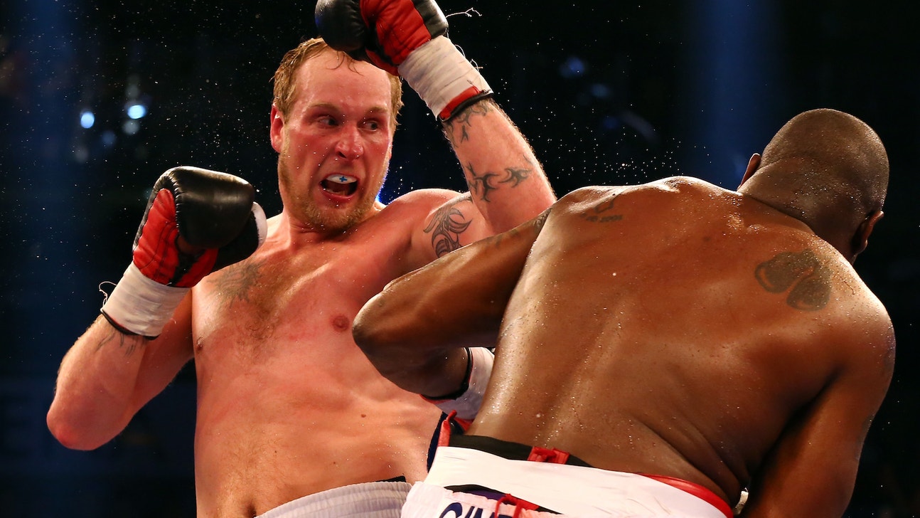 Heavyweight boxer and goalie face off in soccer ball-punching competition