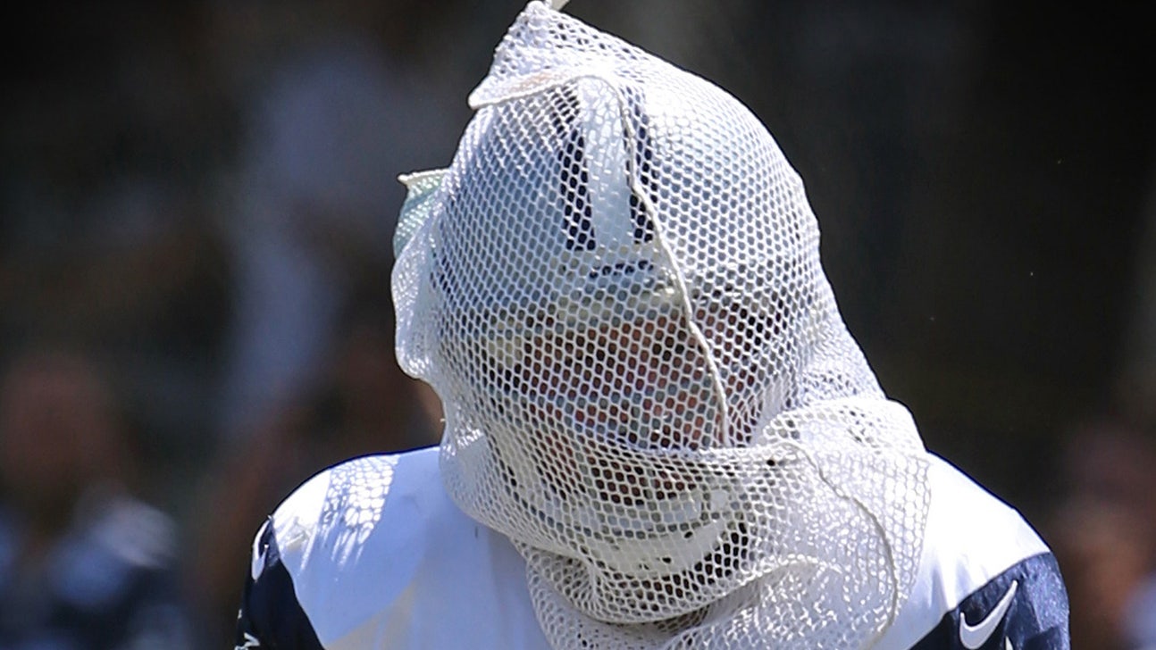 Jason Witten covers himself in mesh netting for pass-catching drill