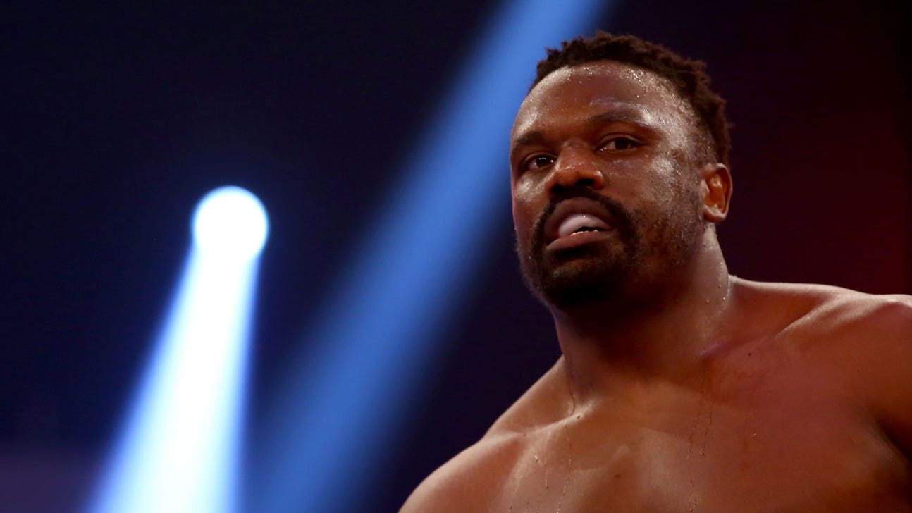 Watch: Extremely heated British boxer throws table at opponent in presser