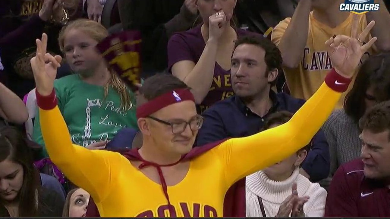 Courtside fan wears a cape and spandex to cheer on the Cavs