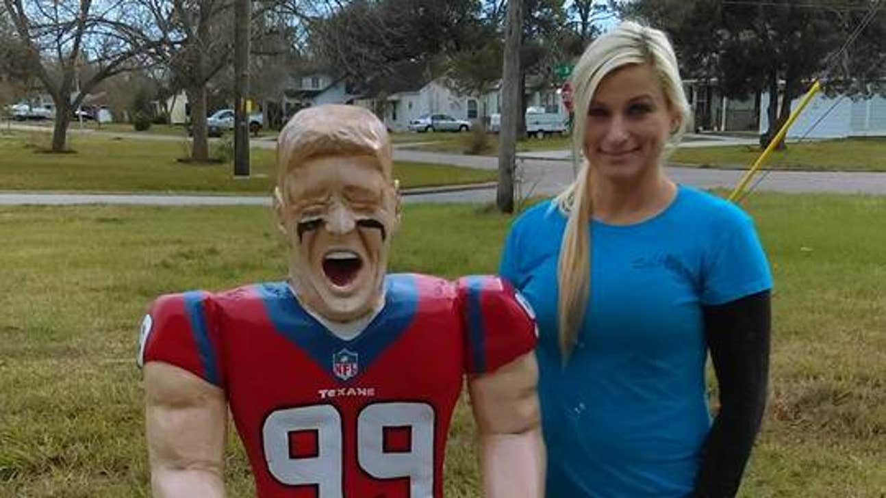 Woman uses chainsaw to carve wooden J.J. Watt statue
