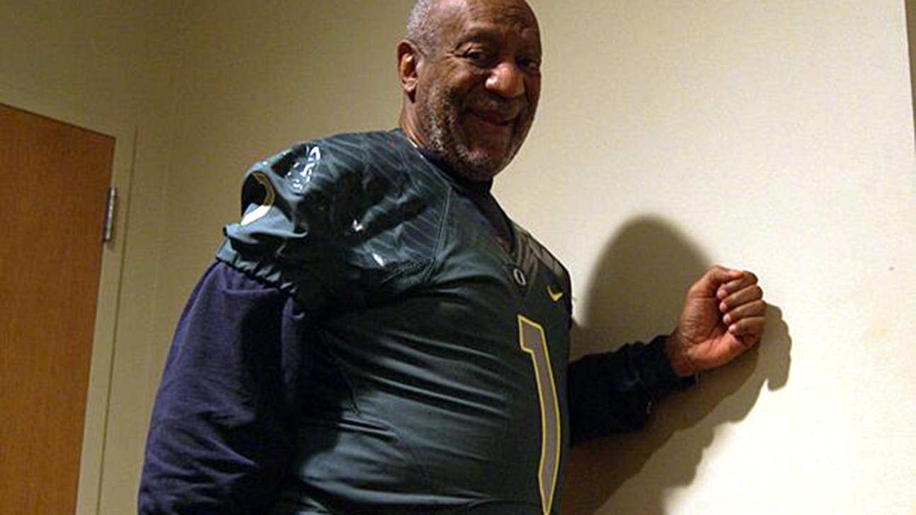 Bill Cosby tries a form-fitting Oregon Ducks jersey on for size