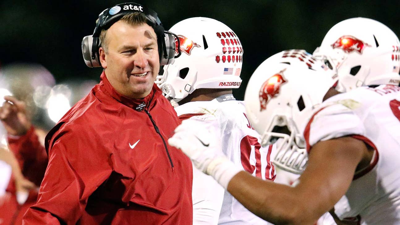 PHOTO: Bret Bielema runs into Gary Pinkel in Columbia