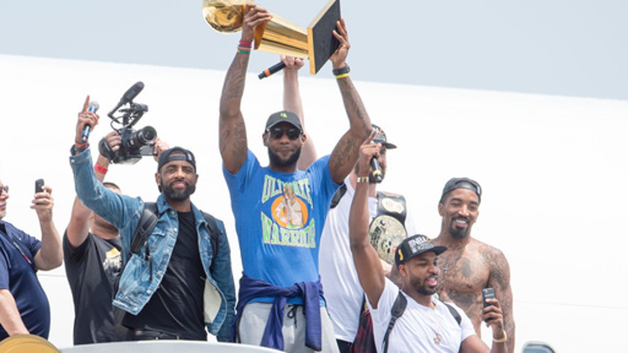 Off the plane but still sky-high, LeBron brings title home