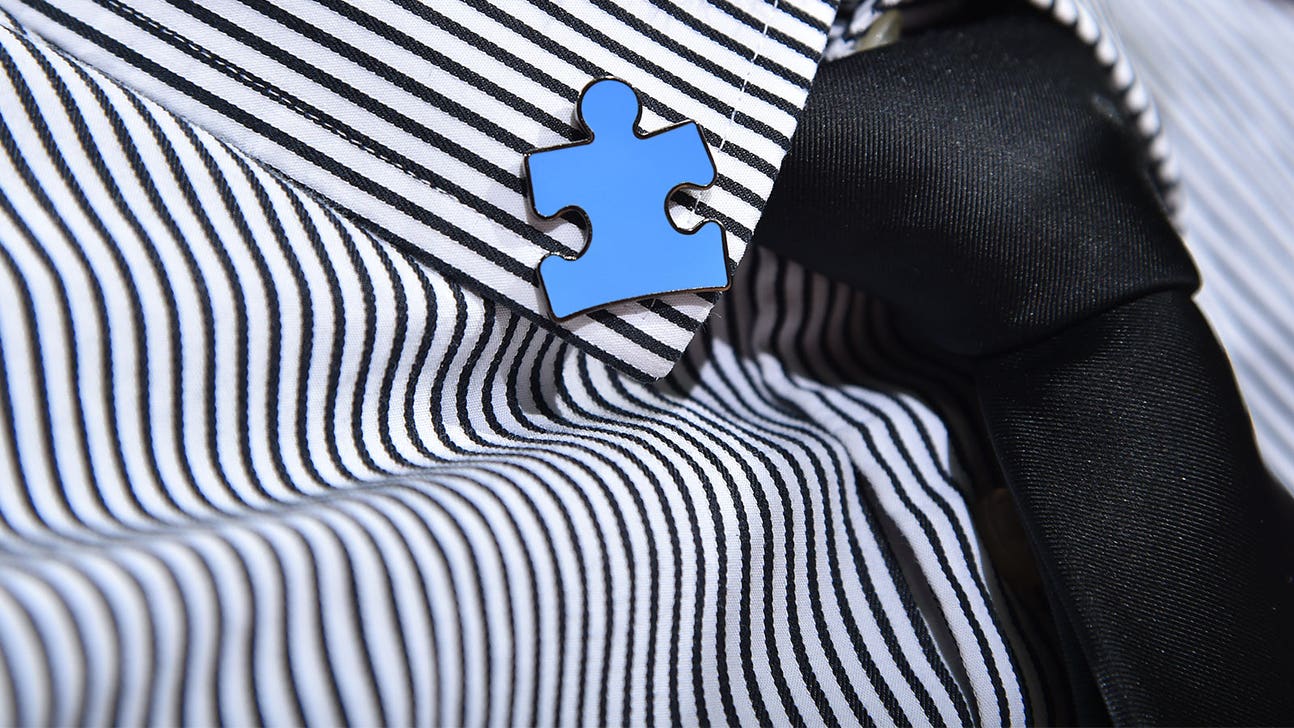 Autism awareness pins have added meaning for two college basketball coaches