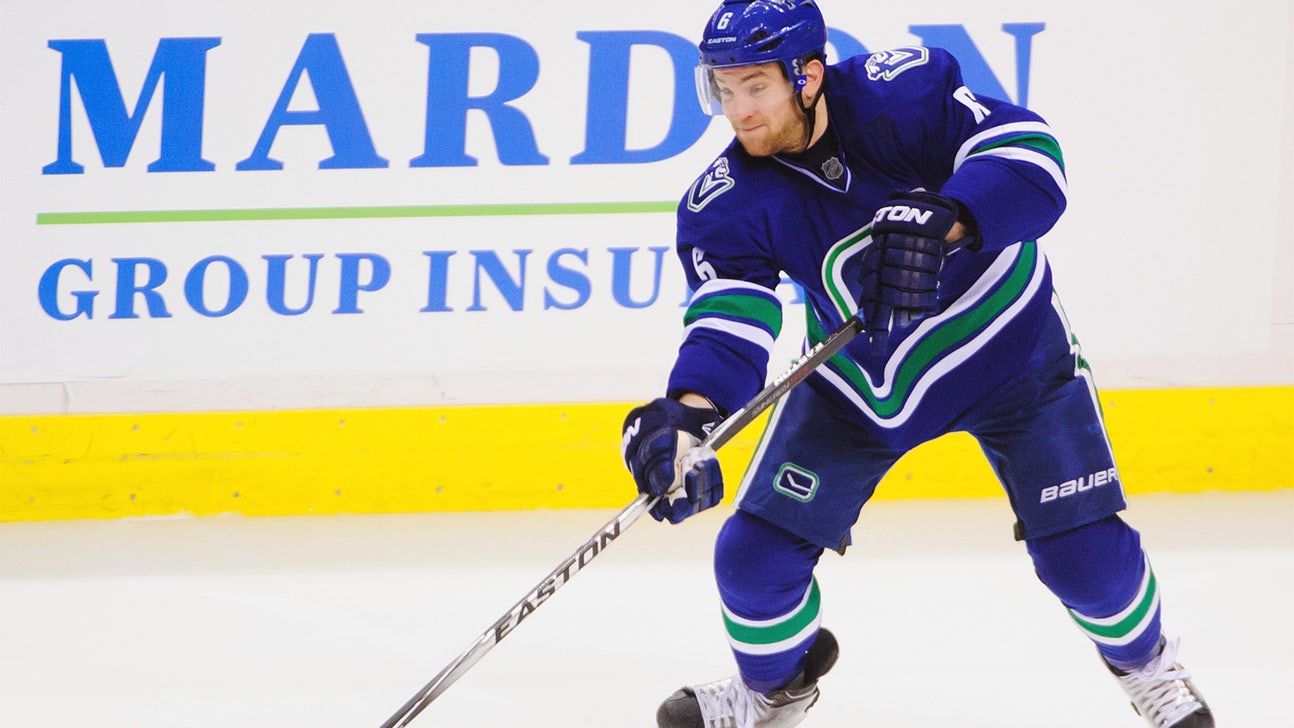 Vancouver Canucks' Yannick Weber lays out ref