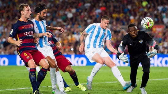 Vermaelen's goal enough as Barca survive scare to edge Malaga
