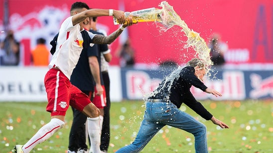 Leipzig head coach pulls hamstring trying to avoid beer shower