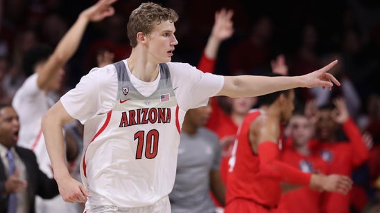 Watch an Arizona Wildcats player hit a wild trick shot from behind the basket