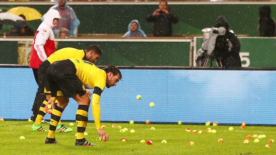 Dortmund fans protest ticket prices with tennis balls