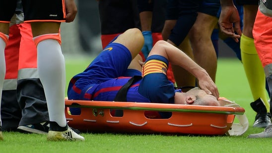 Andres Iniesta stretchered off pitch as Barcelona fear major injury