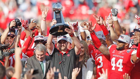 PHOTO: Houston coach Tom Herman shows off his new grill