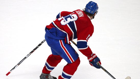 Canadiens' Semin plays game with a stick caught in his jersey