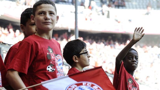 Young migrants applauded by fans before Bayern-Augsburg match