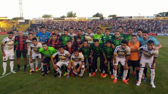 San Lorenzo players wear kits they swapped with Chapecoense players in Copa semis