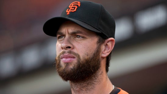 A Giants fan wore a giraffe on his head to salute Brandon Belt