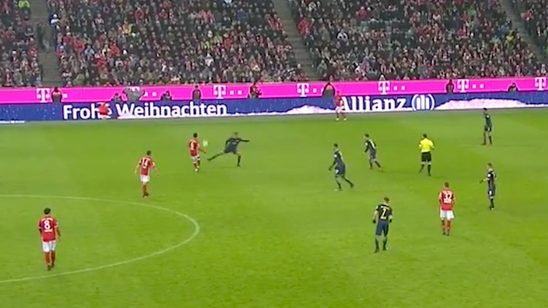 Watch a Bayern Munich player try to pass the ball to a moving Santa ad