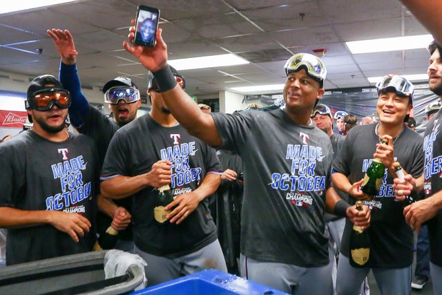 David Ortiz gives Alex Rodriguez a champagne shower while wearing a Red Sox  jersey