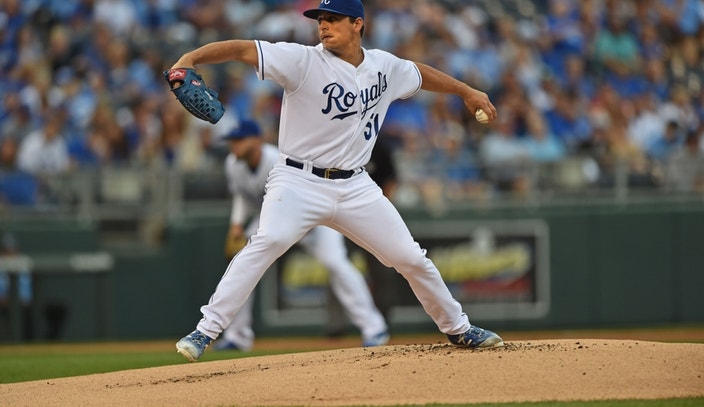 Kansas City Royals pitcher Jason Vargas (L) stops dead in his