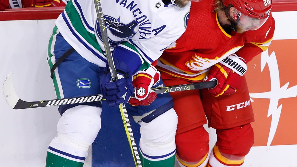 Edler scores in OT, Canucks defeat Flames 3-2
