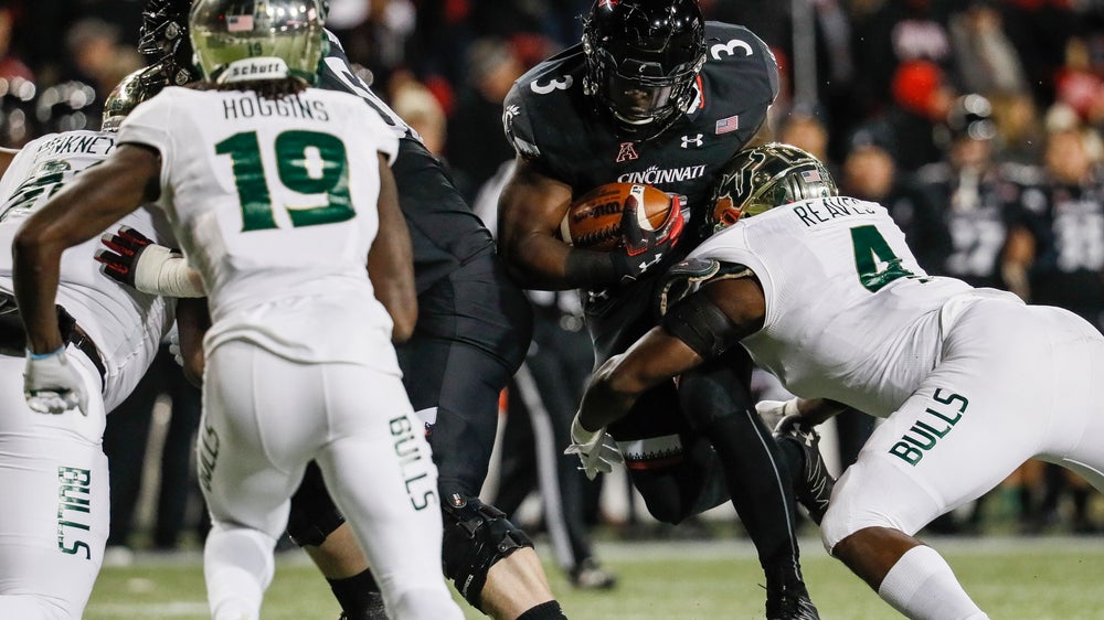 Warren’s 4 TDs lead No. 25 Cincinnati over USF 35-23