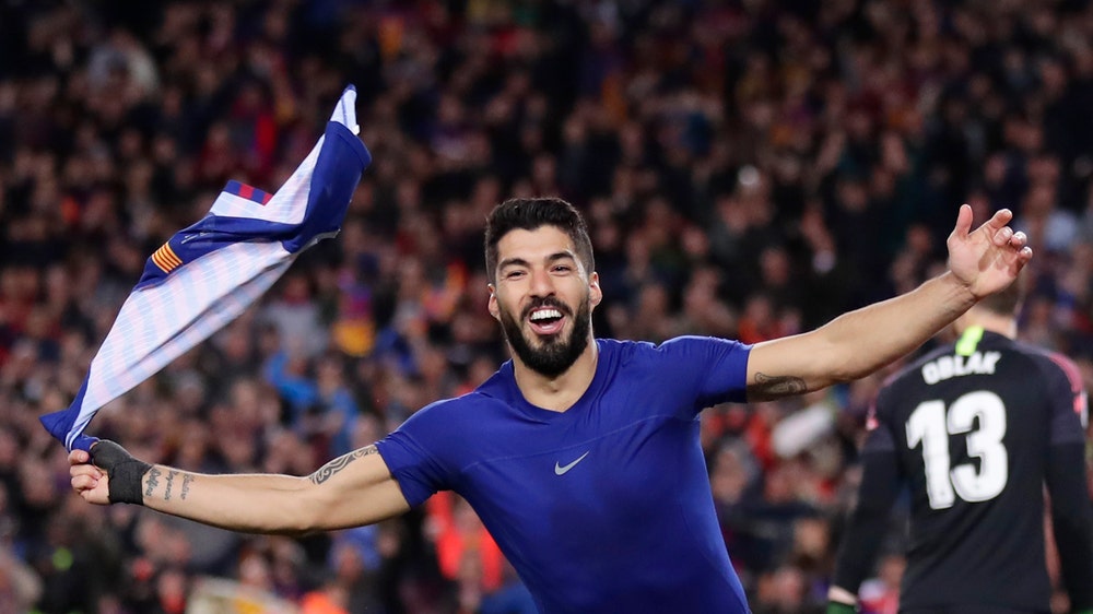 Messi, Suarez lead Barca past 10-man Atletico to boost lead