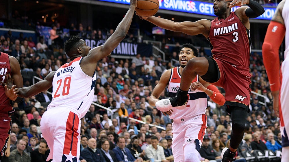 Olynyk’s putback off Wade’s miss lifts Heat past Wiz 113-112