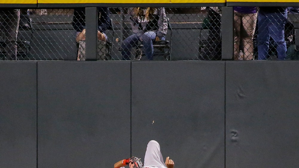 Altherr leaves after hitting fence trying to catch homer