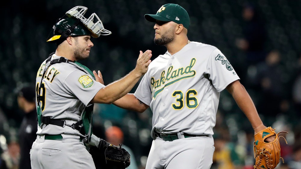 Olson’s slam helps A’s beat Mariners 9-3, close on Yankees