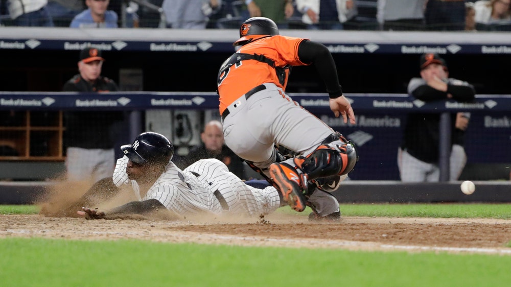 Yanks clinch wild card with 3-2, 11-inning win over Orioles