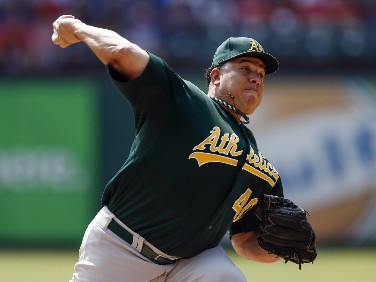 Oakland A's pitcher Bartolo Colon throws to the Seattle Mariners