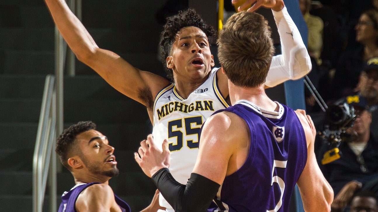 Brazdeikis leads No. 19 Michigan over Holy Cross 56-37